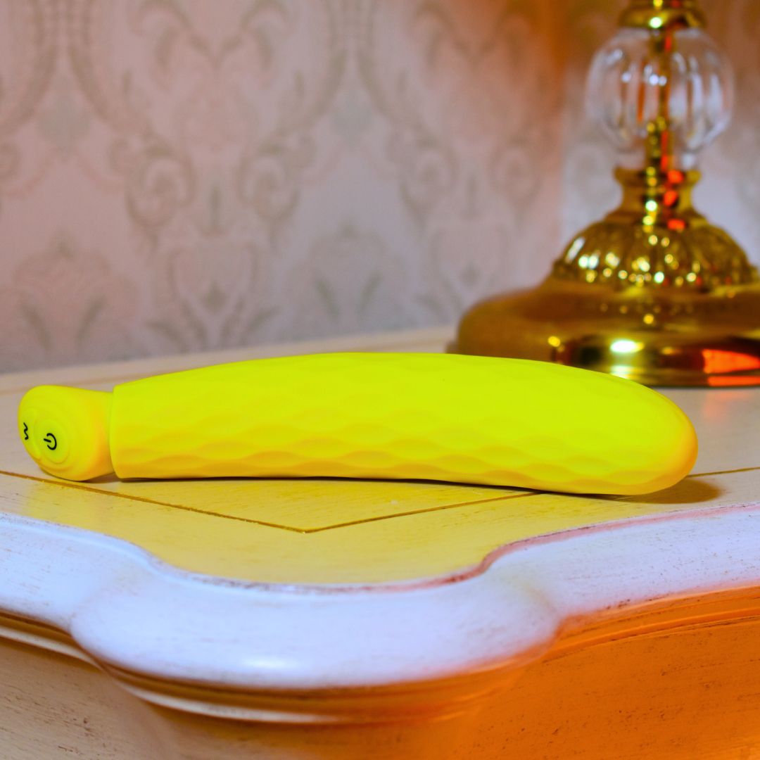 banana shape vibrator on luxury bedside table